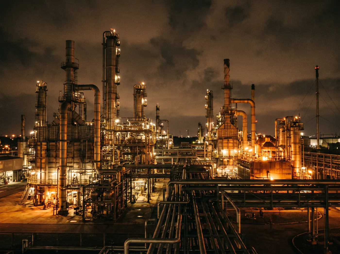 Petrochemical pipework and towers at night